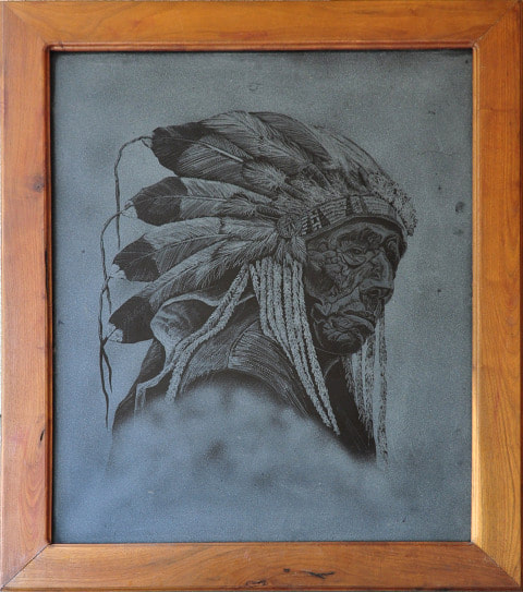 Artwork etched on black glass depicting a Native American chief